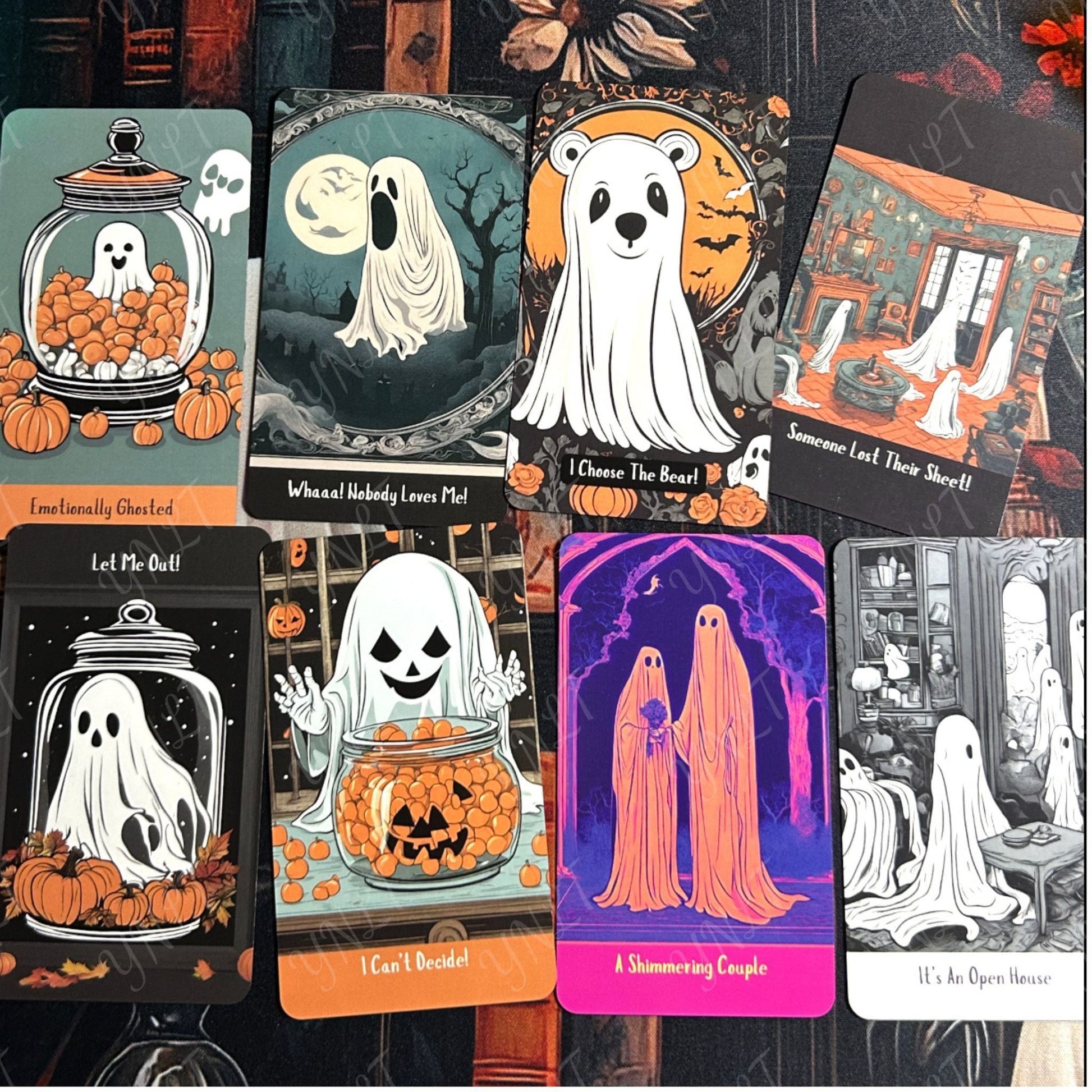 Collection of Halloween-themed tarot cards with ghosts and pumpkins on a dark background.